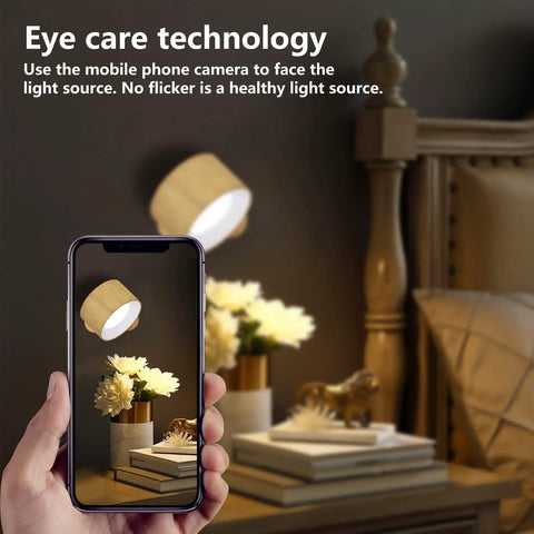 Wall Sconce LED Battery Powered Light With Rechargeable 360 Degree Rotating Magnetic Ball, illuminating a bedroom nightstand.