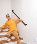 Badass Industrial Wall Mount Stair Handrail, Three Foot Black Iron Staircase Grip Square Tube on indoor stairs with user.