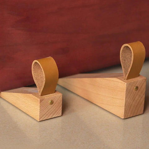 Pair of Walnut Wood Door Stopper Wedge With PU Finish on floor against a brown door, showcasing Nordic style and easy assembly.