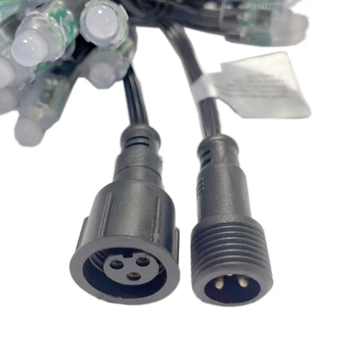 Close-up of connectors on waterproof RGB LED pixel string lights with WS2811 IC, 12mm LEDs for outdoor decor DIY projects.