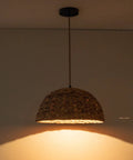Farmhouse Rattan Pendant Light Hand Woven Seagrass Dome Chandelier shown with cozy warm glow in living room.