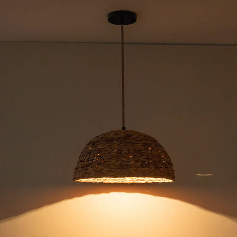 Farmhouse Rattan Pendant Light Hand Woven Seagrass Dome Chandelier shown with cozy warm glow in living room.