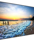Kick Your Visual Game Up A Notch With This Planar 75 Inch 4K UHD LCD Flat Screen Monitor displaying a beach sunset scene.