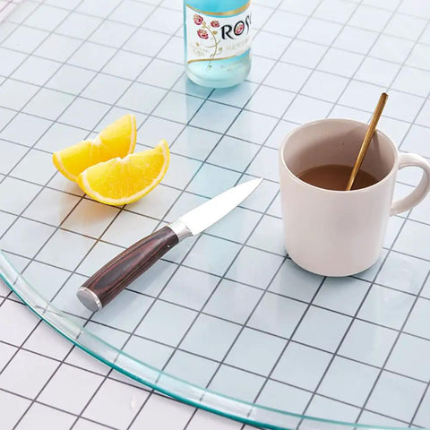 Premium Tempered Glass Lazy Susan Turntable Featuring A Sleek Swivel Design with coffee, knife, and lemon on a dining table.