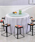 Dining table with Rotating Tabletop Serving Tray With Lazy Susan Turntable For Dining Tables, surrounded by colorful stools.