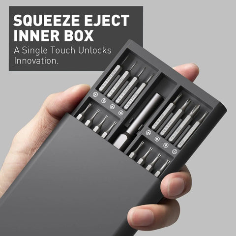 Close-up of a hand holding a 63 In 1 Pro Grade Magnetic Mini Screwdriver Set, showcasing bits in a portable box.