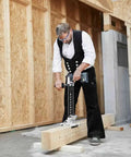 Heavy Duty Brushless Cordless Drill And Driver With Unbreakable Gears And 18 Volt Battery used by contractor on wood beam.