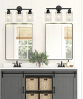 Bathroom mirrors with wall-mounted lantern lights above sinks on a grey cabinet with baskets