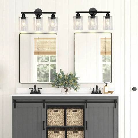 Bathroom mirrors with wall-mounted lantern lights above sinks on a grey cabinet with baskets