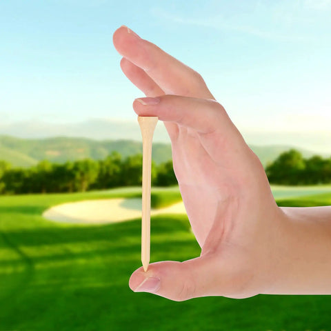 Hand holding a Durable Bamboo Golf Tees 100 Pack 3.25 Inches Long Biodegradable Eco Friendly Tees For Stable Drives Low Friction Side Spin