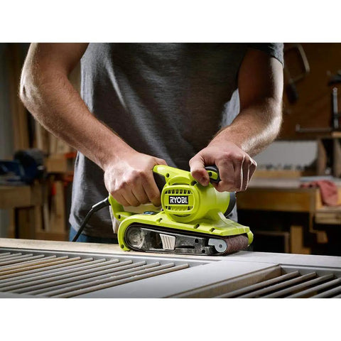 Person using Portable Corded Belt Sander with 6 Amp Power, 320 Feet Per Minute Speed, 3 by 18 Inch Belt on wood in workshop