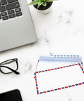 Retro Airmail Envelopes With Aviation Stripes Pack Of 5 10 Or 20 next to glasses and laptop on marble surface