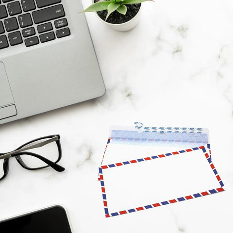 Retro Airmail Envelopes With Aviation Stripes Pack Of 5 10 Or 20 next to glasses and laptop on marble surface