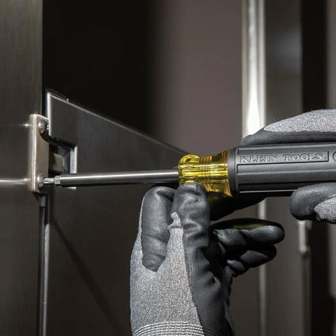Using Grab And Go Multi Bit Tamperproof Screwdriver Kit with Twenty Six Onboard Bits and Quarter Inch Nut Driver on metal hinge.