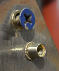 Close-up of rivet nut and blue screw from Heavy Duty Rivet Nut Kit 500 Piece Galvanized Carbon Steel Assortment With M3 M4 M5 M6 M8 M10 Threads Built Tough For Home DIY Projects And Industrial Jobs Comes In A Durable Storage Box