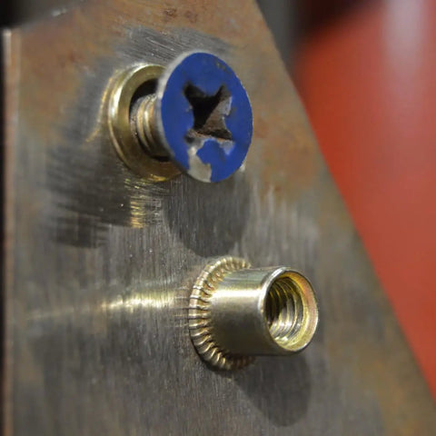 Close-up of rivet nut and blue screw from Heavy Duty Rivet Nut Kit 500 Piece Galvanized Carbon Steel Assortment With M3 M4 M5 M6 M8 M10 Threads Built Tough For Home DIY Projects And Industrial Jobs Comes In A Durable Storage Box