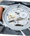 Close-up of Clock Movement Nut Set With Washers 14 Pcs Replacement Parts Kit on a watch mechanism for easy repair.