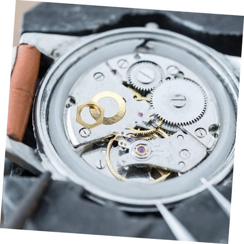 Close-up of Clock Movement Nut Set With Washers 14 Pcs Replacement Parts Kit on a watch mechanism for easy repair.