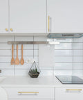 10 Pack 5 Inch Brushed Brass Knurled Cabinet Handles for Kitchen Cabinets Gold Pulls and Door Hardware installed on white kitchen cabinetry