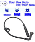 Rear disc brake pad wear sensor cable with black plastic sensor housing and connector, front view.