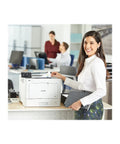 High Output Color Laser Printer With Frictionless Wireless Connection And Automatic Duplex Printing Optimized For Budget Conscious Buyers Who Want Serious Bang For Their Buck Daily in office setting with woman using printer.