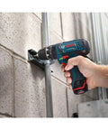 Hand holding 12V Max 3/8 Inch Hammer Drill Driver Bare Tool for Pros drilling into concrete wall, showcasing ultra lightweight power.