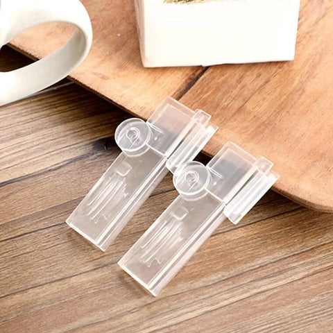 Premium Set Of 10 Transparent Milk Carton Lid Clips For Bags, Reusable Sealers To Keep Food Fresh Longer, two clips on wooden surface