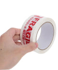 Hand holding Fragile Warning Packing Tape Set with 5 Rolls, Heavy Duty Shipping Tape That Sticks Like Crazy, Bright Handle With Care Labels