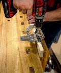 Weekend Hobbyist Stainless Dowelling Jig Kit With One Quarter Inch, Three Eighth Inch, And One Half Inch Holes in use on wooden workbench