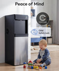 Top Shelf 4-In-1 Countertop Water Dispenser Plus Fast Ice Maker With Bottom Loading Cooler Hands Hot Cold Or Mild Drinks Makes 33 Lbs Of Quick Chill Cubes Daily Boasts Child Lock For 3 5 Gallon Bottles For Smooth Office Hydration In Glossy Black next to a child playing with blocks.