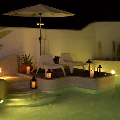 Large 4x10 Waterproof Outdoor Flameless Candles by poolside with lanterns at night, LED pillar lights with flickering effect.