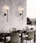 Industrial Gold And Black 1 Light Wall Sconce With Long Arm And Globe Glass Shade Delivers A Lit Glow Modern Wall Mounted Lamp For Bedroom Hallway Clear Glass Set Of 2 on a brick wall in dining area