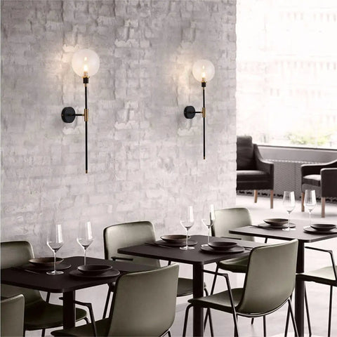 Industrial Gold And Black 1 Light Wall Sconce With Long Arm And Globe Glass Shade Delivers A Lit Glow Modern Wall Mounted Lamp For Bedroom Hallway Clear Glass Set Of 2 on a brick wall in dining area