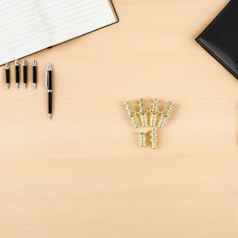 Metal Table Pins And Dowels Set For Furniture Joints And Desk Assembly on a wooden desk with pens and notebook
