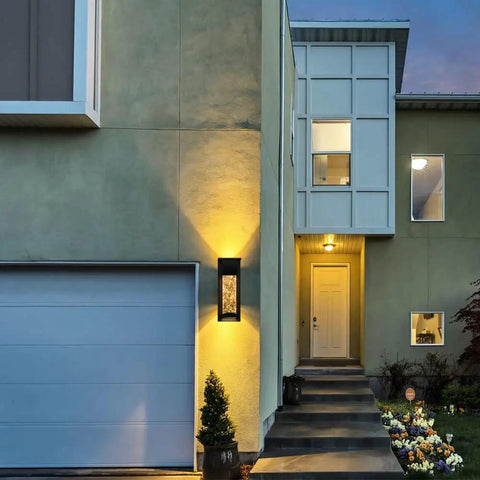 2 Pack Crystal LED Wall Lights with Frosted Matte Shade illuminating a modern home entrance at dusk.
