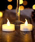 24 Pack Flickering LED Tea Lights With Timer 6 Hour Auto On Off Battery Operated Flameless Tealights glowing on a table