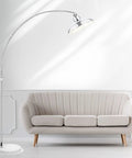 Ultra Sleek Arc Floor Lamp With Adjustable Silver Finish, 77 Inch Arch next to modern beige sofa in bright living room