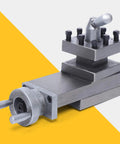 Front view of AT300 industrial swing lathe tool post assembly in gray metal with bolts and graduated dial.