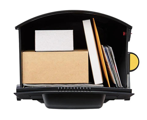 Interior view of Patriot Large Capacity Rust Proof Plastic Post Mount Mailbox in Black with packages and magazines inside.