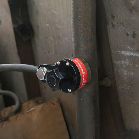 Magnetic Welding Ground Clamp with On Off Switch 40 Kg Pull 300 Amp Rated attached to a metal pipe for welding use.