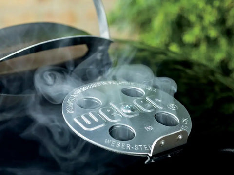 Close-up of the vent and smoke on Original Kettle Premium Charcoal Grill 22 Inch Black Outdoor BBQ Grill With Built In Thermometer