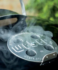 Close-up of temperature control on Original Kettle Charcoal Grill 22-Inch Black With One-Touch Cleaning System, emitting smoke