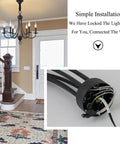 Six Light Black Farmhouse Chandelier With Industrial Modern Vibe Candle Style Hanging Light Fixture shown in entryway