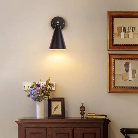 Modern Black And Gold Wall Sconces Set With Swing Arm Industrial Lamps Rustic Bronze Finish Two Pack For Bedroom Living Room Reading Kitchen Easy Install Farmhouse Style Wall Lights illuminating a room with flowers and artwork on a table.