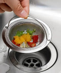 Ditch the Plumbing Headache Forever with This Tough Stainless Steel Sink Strainer Mesh Drain Catcher Filter Screen trapping food scraps.