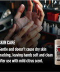 Hands applying Heavy Duty Walnut Hand Scrub and Cleaner 16 Oz in a garage setting for soft, clean skin