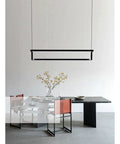 Modern LED Pendant Light Rock Solid Aluminum Body With Effortless Remote Dimming And Soft Warm White Glow above a dining table.