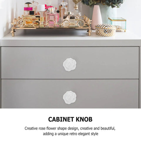 White Ceramic Rose Flower Cabinet Pull Handles With Screws, 8 Pack for Cabinets, Drawers, Dressers and Wardrobes, shown on a dresser