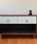 Wooden cabinet featuring modern metal cabinet door knobs and wardrobe drawer pulls for single hole install, gold finish.