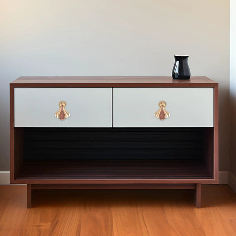 Wooden cabinet featuring modern metal cabinet door knobs and wardrobe drawer pulls for single hole install, gold finish.
